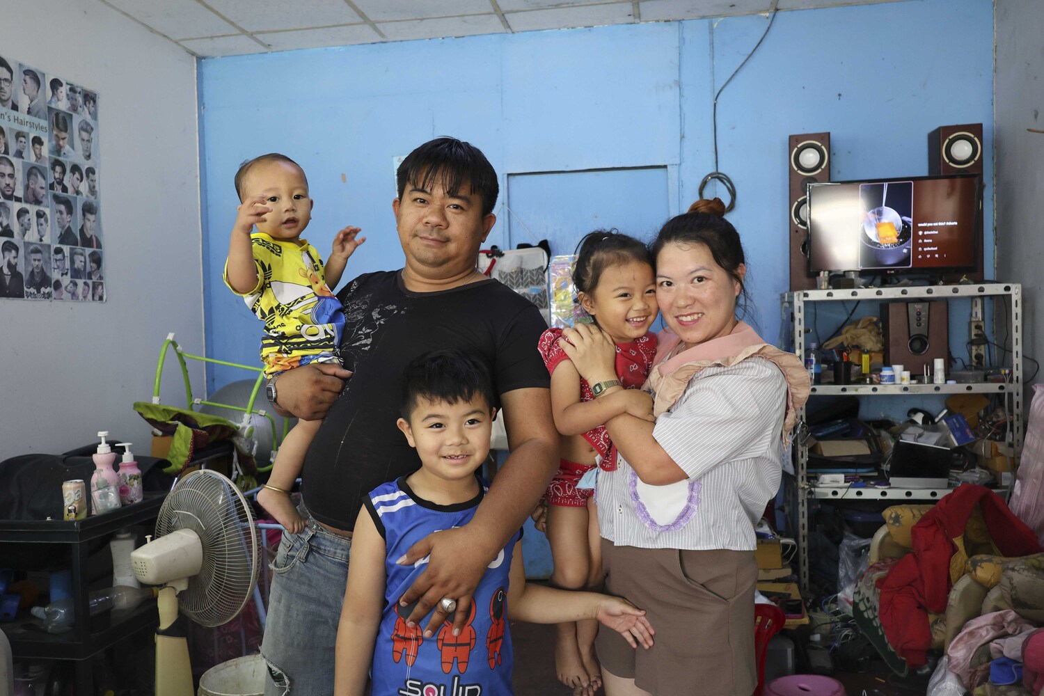 Sibthit with his mom, dad, little sister, and little brother, all smiling joyfully at the camera.