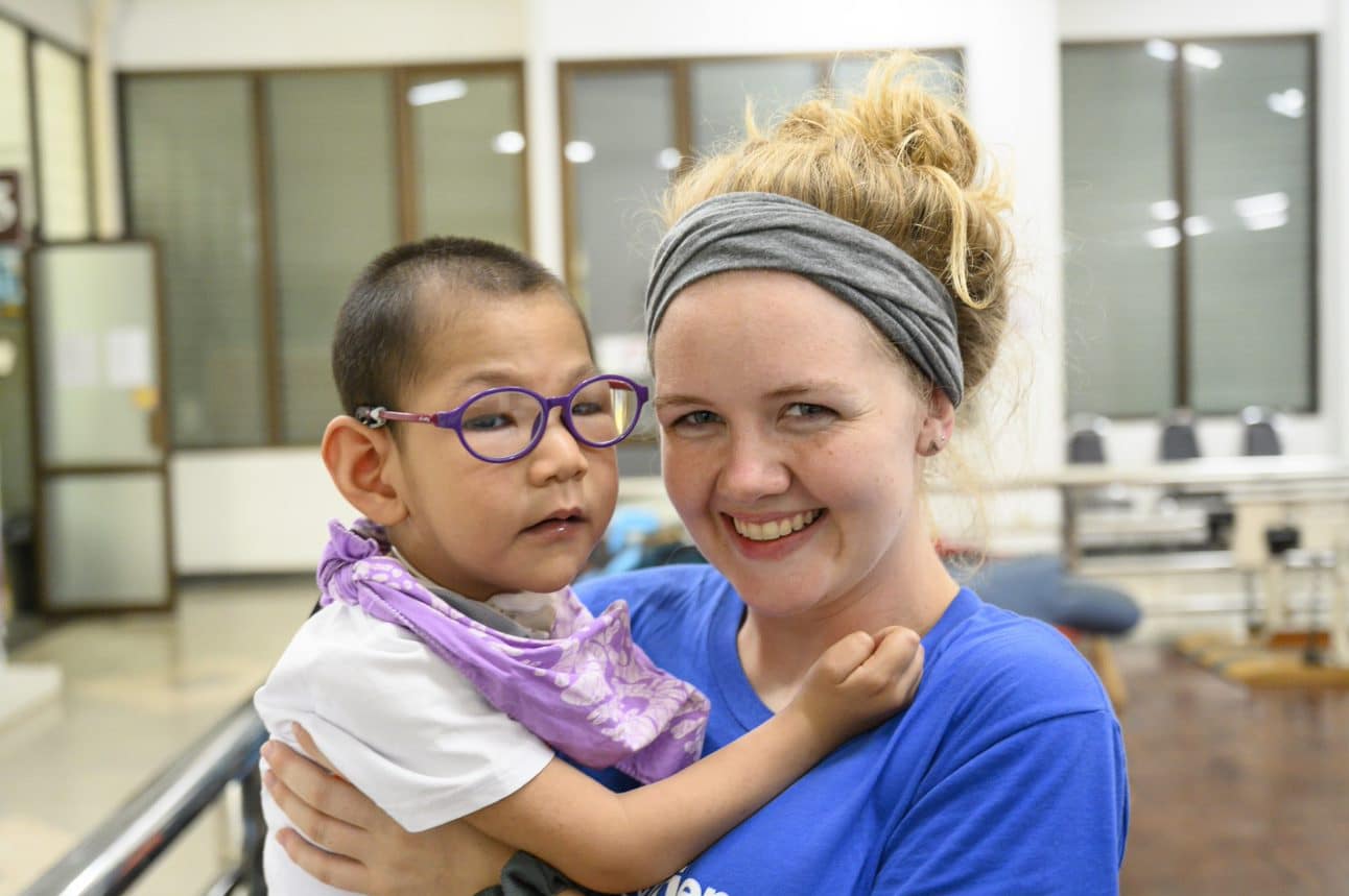 Missions And Ministry Elyse And Boy An intern embraces a child