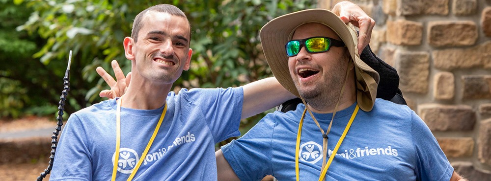 two campers smiling at the camera.