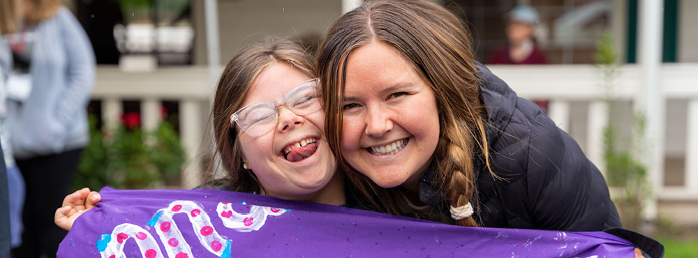 A volunteer and teen camper are so excited to be at Family Retreat.
