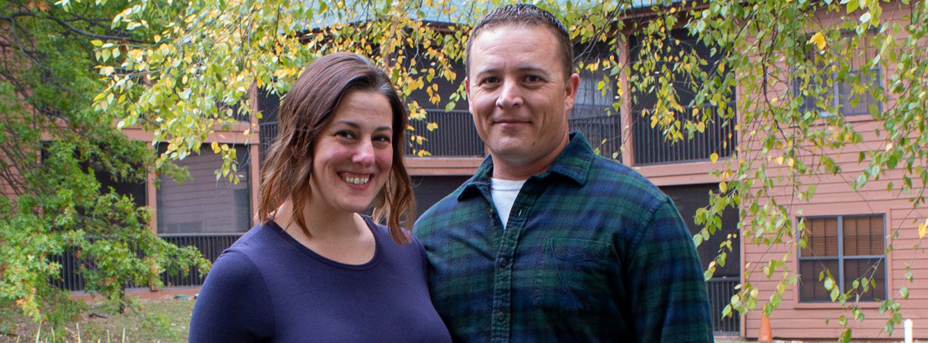 A couple poses for a photo at Marriage Getaway