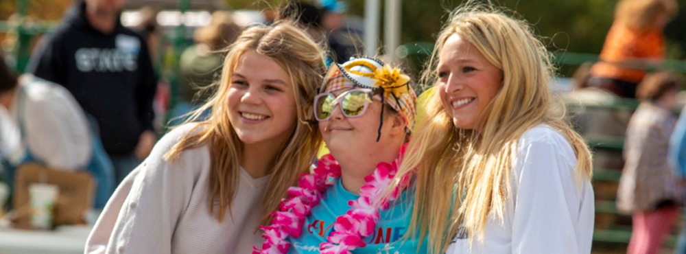 Barnyard Bash attendees have huge smiles on their faces. They are having a blast at Barnyard Bash!