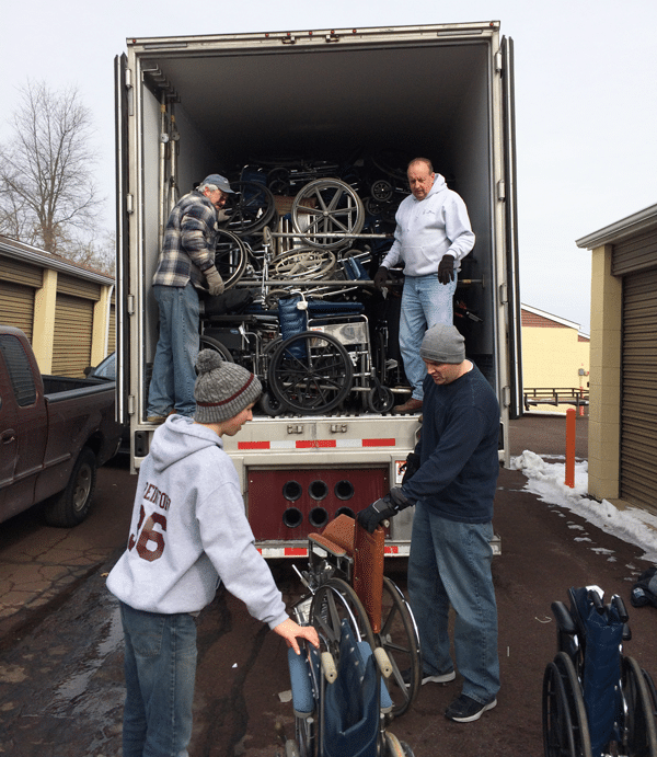wheelchair-collection-philly Volunteers loading a truck with wheelchairs